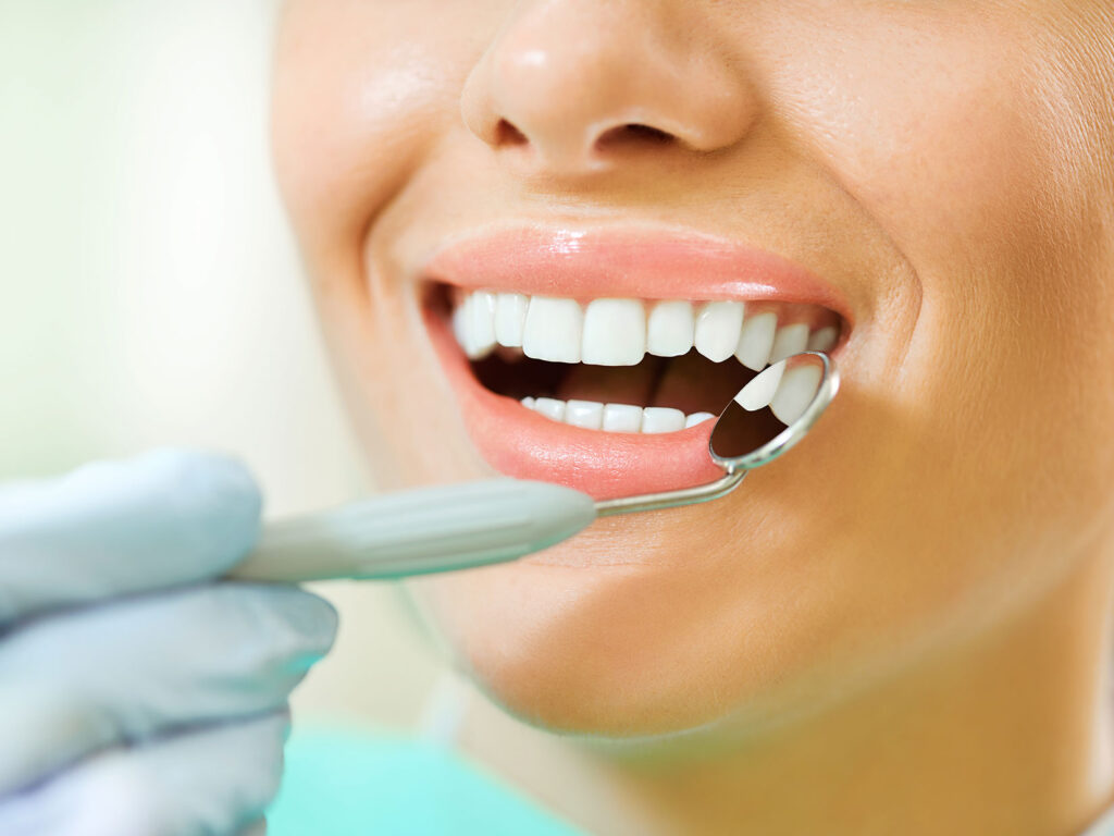 close up of mouth with dental mirror